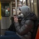 A man wearing a face mask on the subway