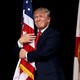 Donald Trump hugging an American flag