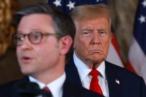 Donald Trump seen scowling, with House Speaker Mike Johnson in the foreground.
