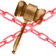 A gavel behind an X composed of red chains
