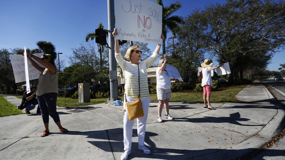 A teacher holds up an anti-gun sign. 