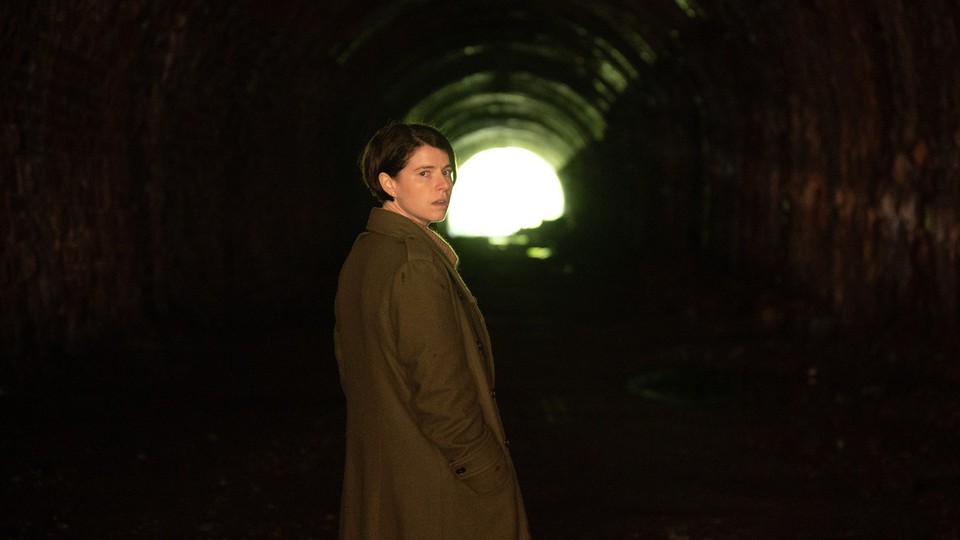 Jessie Buckley looks over her shoulder in a tunnel in the movie "Men."