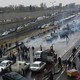 People park their cars on a crowded highway in Tehran to protest rising gas prices.