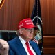 President Donald Trump, wearing a red hat, and Vice President J. D. Vance sit in the Situation Room at the White House.
