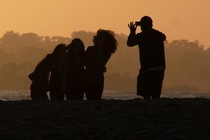 Man taking a photo of a group with a smartphone