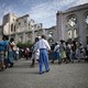 A procession walks past the ruins of the Notre-Dame de l'Assomption cathedral, destroyed in the 2010 earthquake.