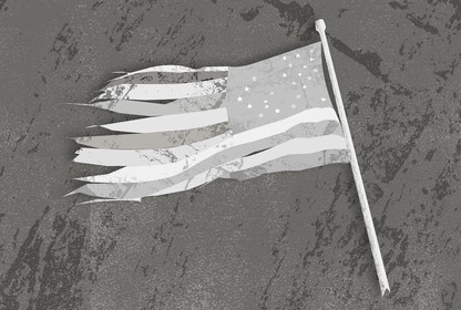 A tattered black-and-white American flag lying on the ground