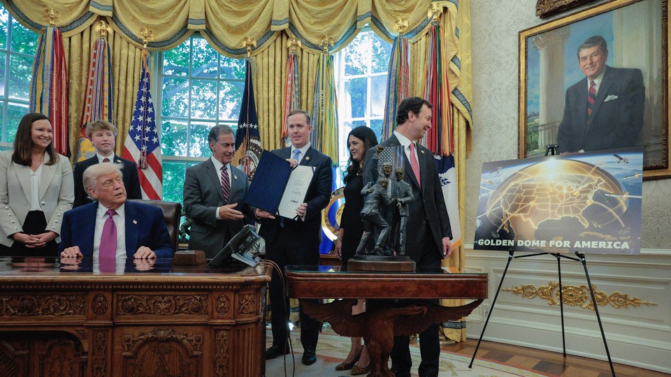 Photograph of Trump and other officials with a sign for the Golden Dome in the White House