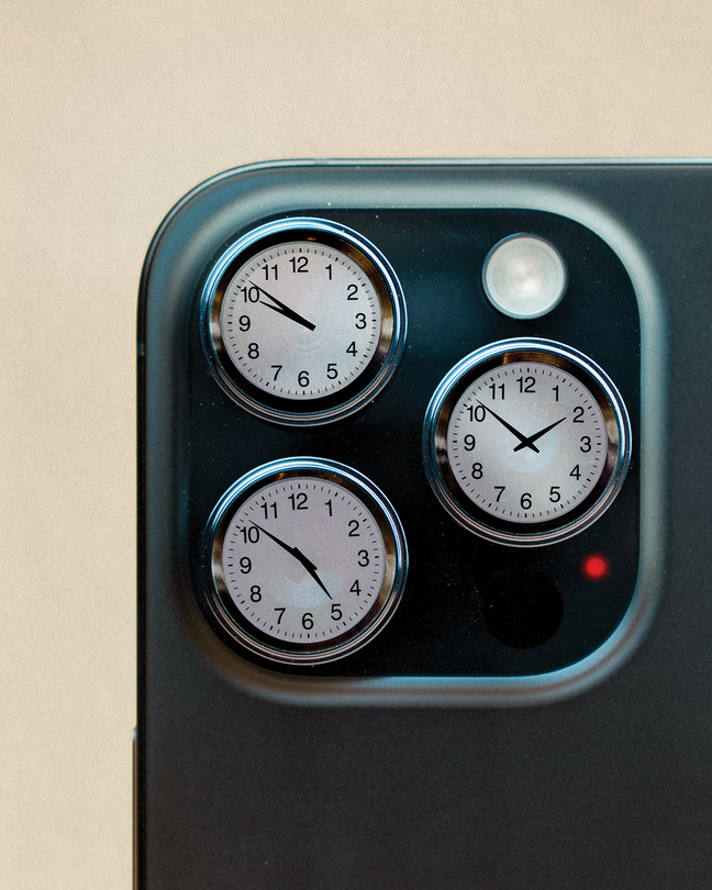 Photo-illustration of close-up detail of smartphone camera with three lenses, each replaced by a round clock showing a different time.