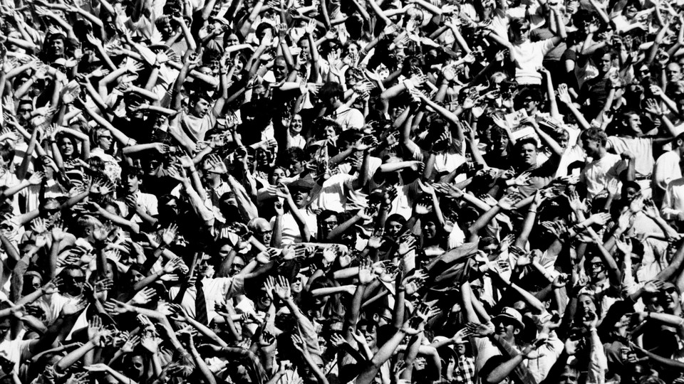 A group of students throwing their arms in the air