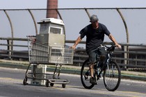 A man hauls air conditioners with his bike in New York.