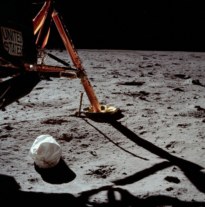 Armstrong's photo of the landing area on lunar surface, and one leg of the lunar module.