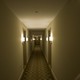 A long, dimly lit hallway with a patterned rug