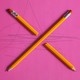 Two pencils, one broken, form an X