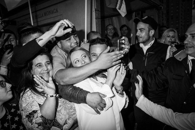 Meloni taking a selfie with fans