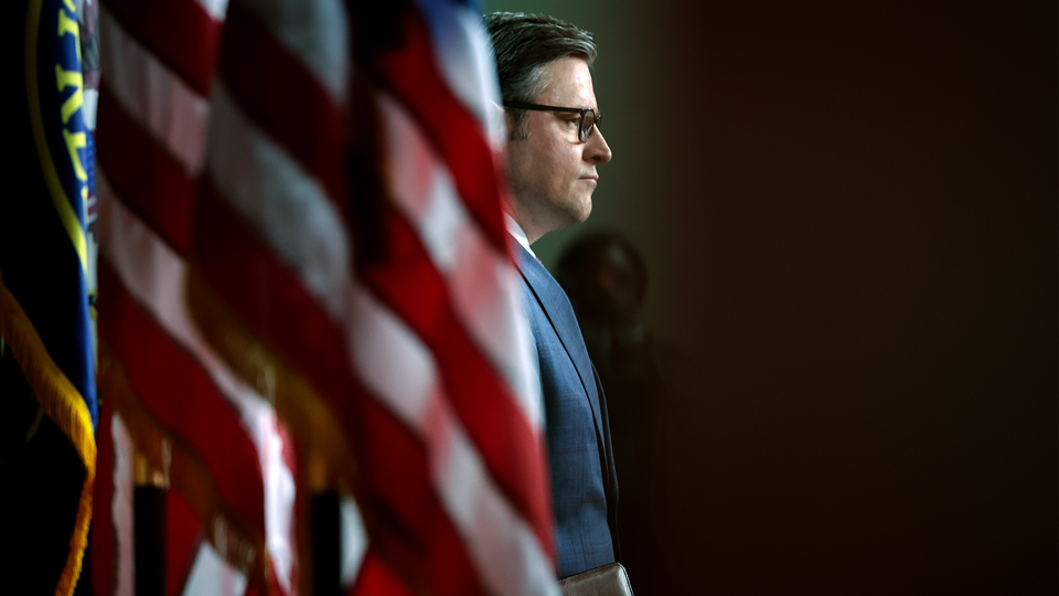 Mike Johnson with an American flag