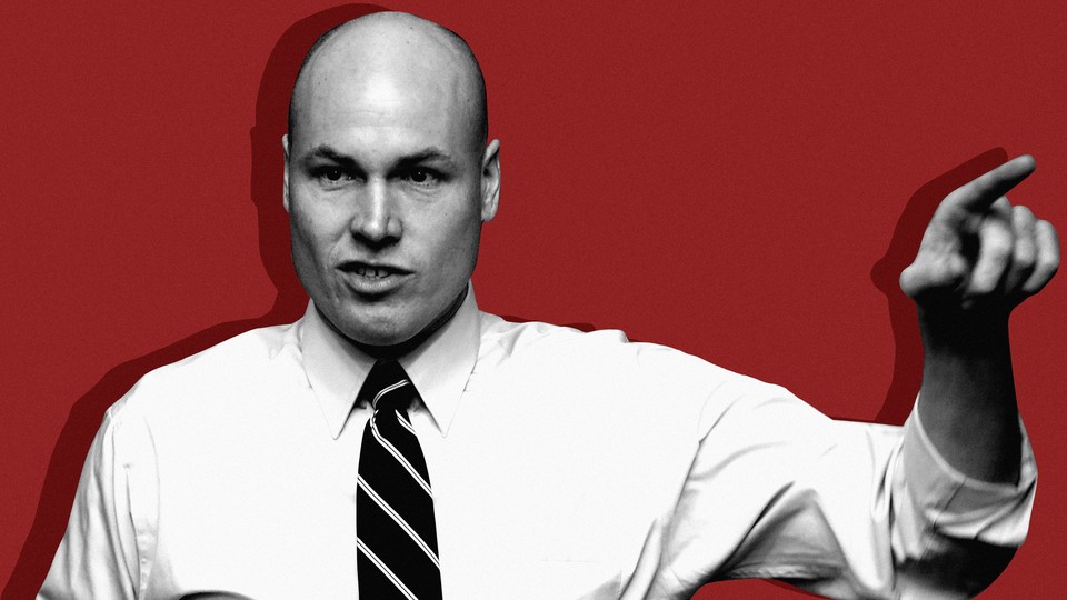 J. D. Scholten, the House candidate in Iowa, appears in a black-and-white photo, in front of a red background. He is pointing his left hand.
