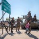 YPG fighters stand with a child near a tank in Raqqa in 2015