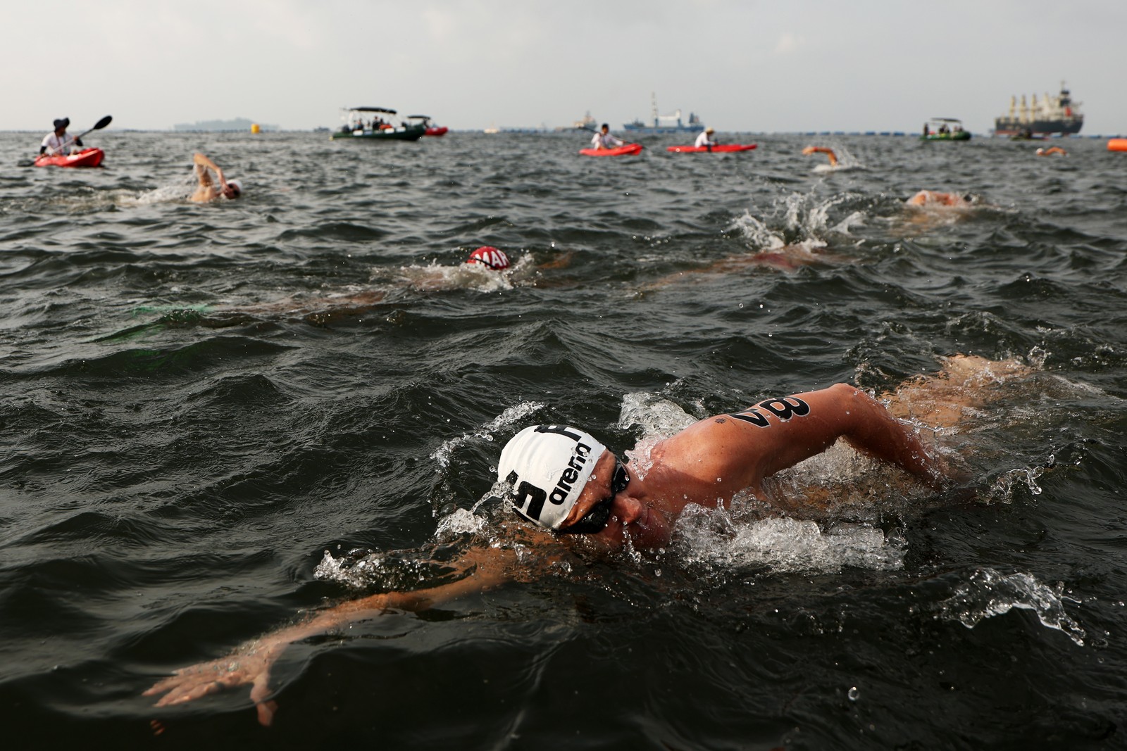 Swimmers compete in open water.