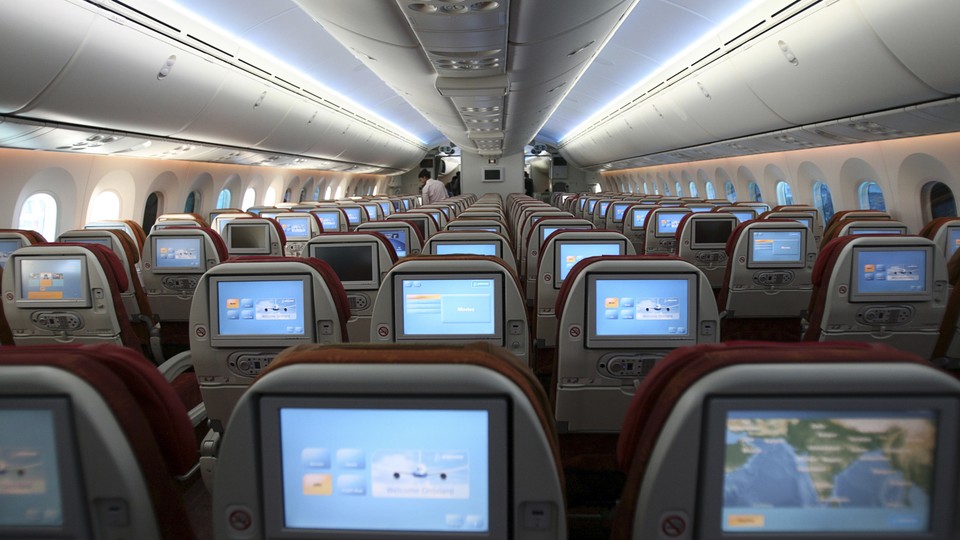 Rows of airplane seats viewed from behind