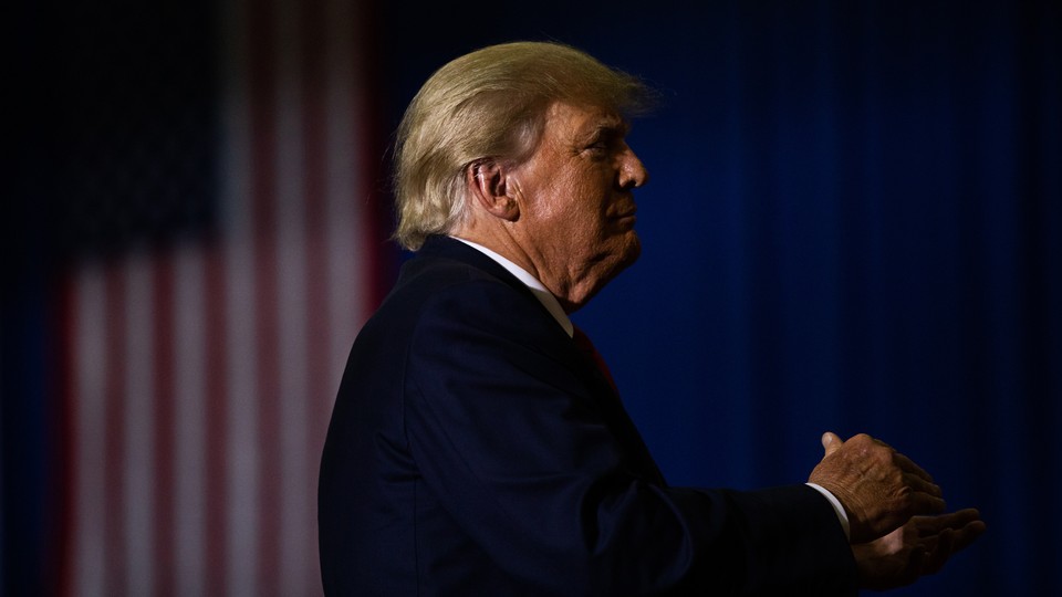 Former President Donald Trump claps during a Save America rally in Warren, Michigan, on October 1, 2022.