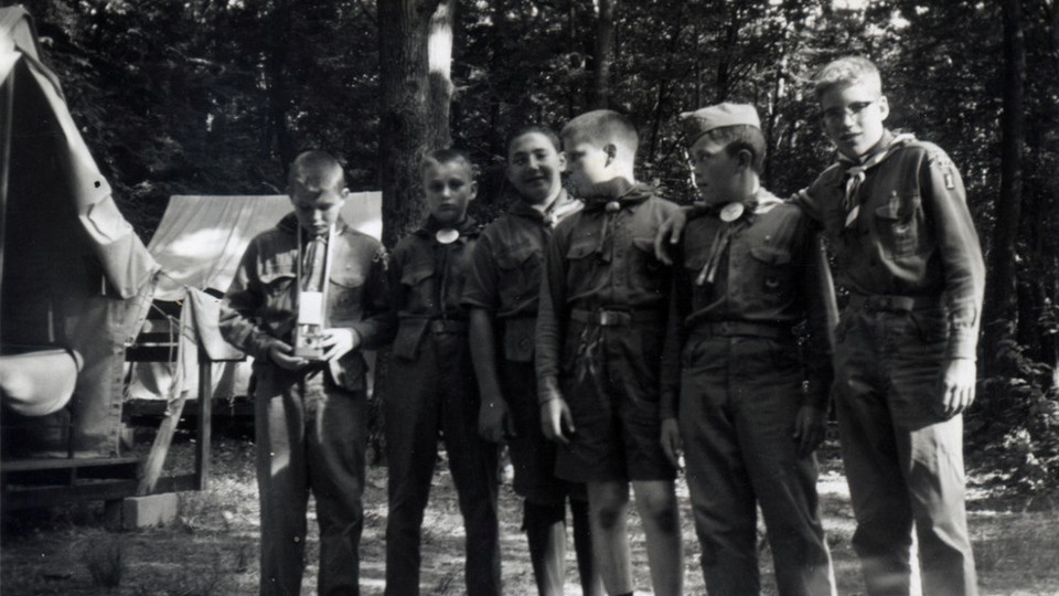 Boy Scouts stand together in a line.