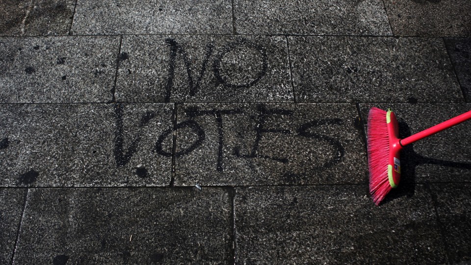 "NO VOTES" is spray-painted on the ground.