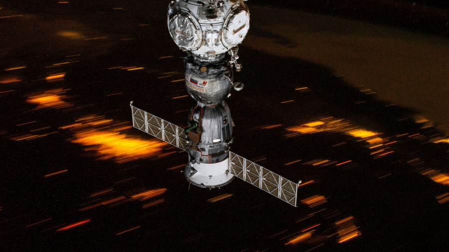 A night view of city lights, seen from orbit, slightly motion-blurred