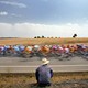 A man looks at a pack of bicyclists during the Tour of Spain in 2005.