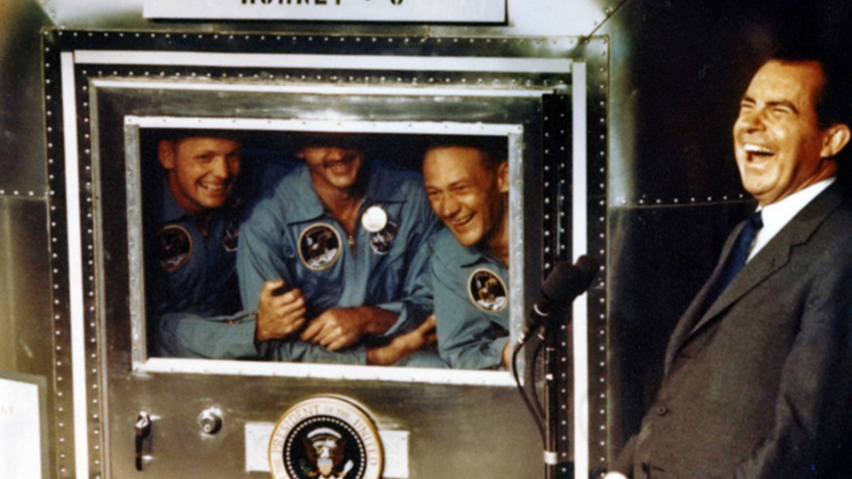 The Apollo XI astronauts Neil Armstrong, Michael Collins, and Buzz Aldrin laugh with President Richard Nixon aboard the USS Hornet in 1969.