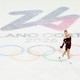 Photograph of Amber Glenn in a red dress ice skating over the logo for the 2026 Olympics