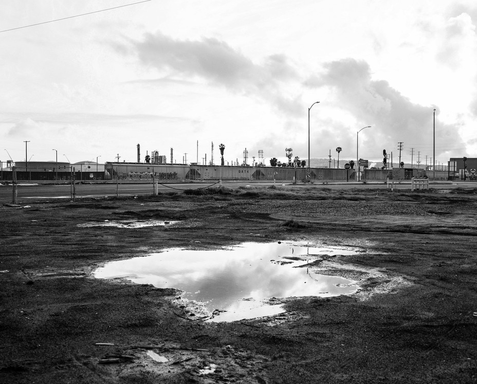 Near the Terminal Island freeway on the cusp of West Long Beach and Wilmington, Calif., overlooking the railroad that connects to the ports and the Valero refinery. This sector is contaminated with industrial waste. Pablo Unzueta/ Magnum Foundation