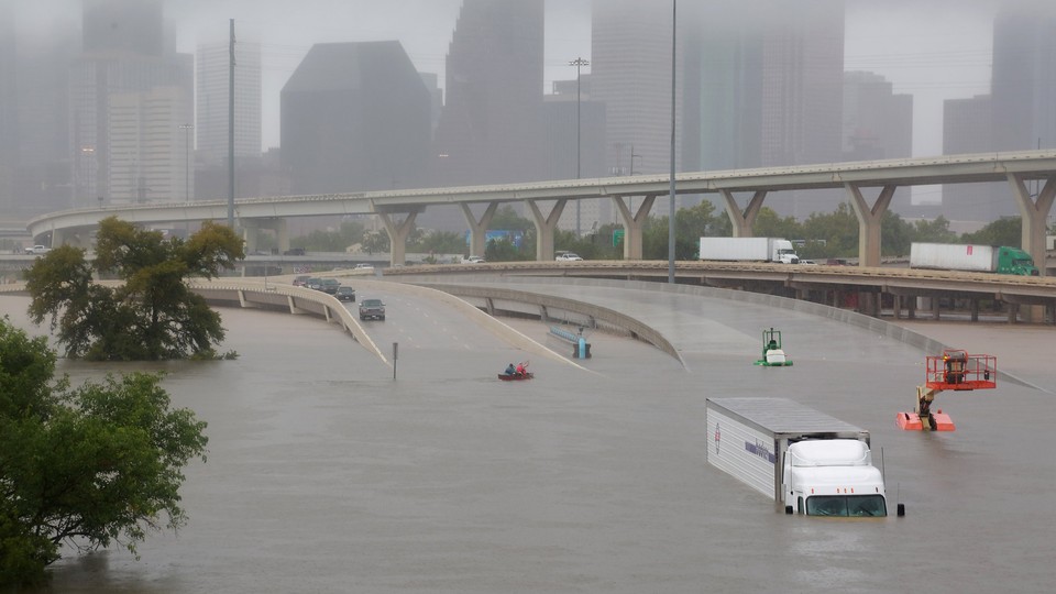 Interstate 45 submerged in Houston with parked cars and trucks