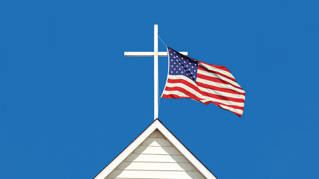 An image of the American flag flying next to a cross