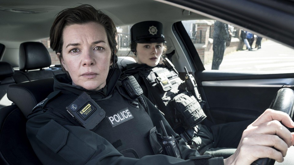 Two female cops from Blue Lights sit in a car