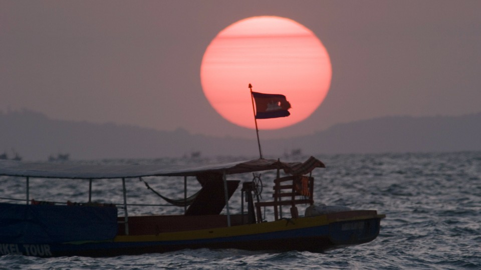 A fishing boat near Sihanoukville flies the Cambodian flag.