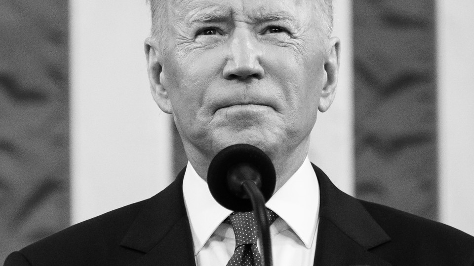 Joe Biden in front of microphone in black and white