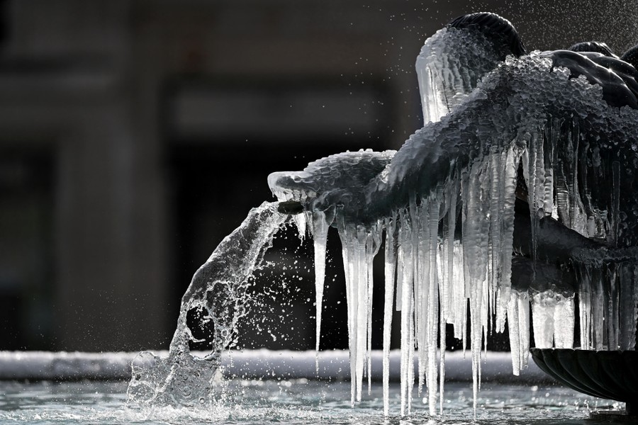 Icicles hang from a frozen statue.