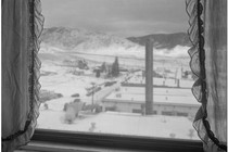 A window overlooking snowy hills