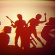 Distorted image of a rock band in silhouette, seen on a monitor