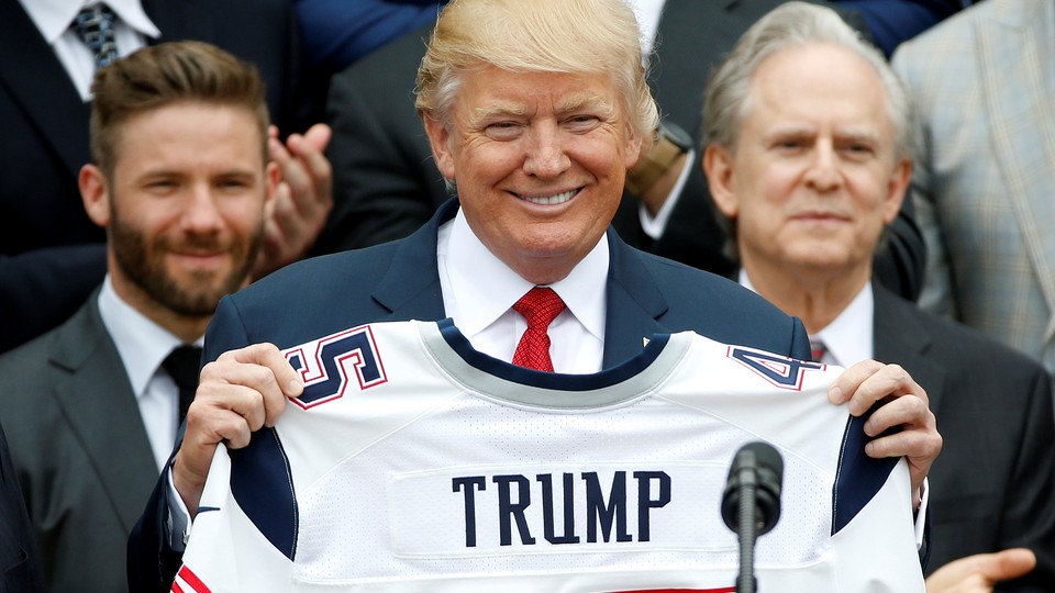President Trump holds up a jersey with his name on it