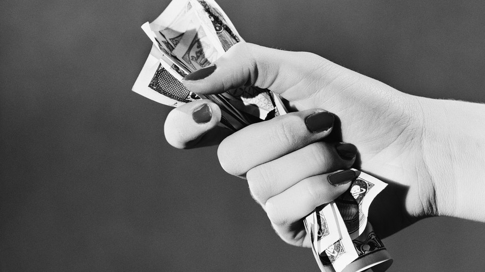 Woman holding fist full of cash