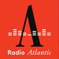 A photo splice of the black-and-white "Radio Atlantic" logo on a red background (on the left) and a photo of the Ukrainian flag in a damaged cityscape (on the right)