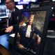 A photo of a framed portrait of Donald Trump and a Trump hat sitting on a desk at the New York Stock Exchange