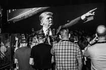 A black-and-white photo of a crowd waiting to hear former President Donald Trump speak at a Turning Point–sponsored event in Phoenix on June 6.