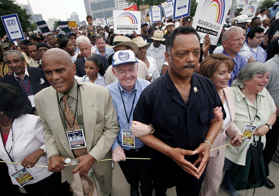 A crowd of people marches together.