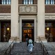 A student walks up the steps of Harvard University