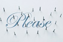 The word "please" in cursive script on a white background, pierced by nails poking through