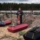 A Ukrainian priest buries the victims of the Bucha massacre. 