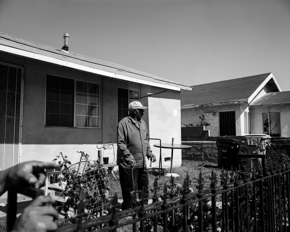 Hilary Landreaux, 80, stands in front of his home as 18-wheeler trucks from the Los Angeles ports roar down the street in Wilmington, Calif., a Los Angeles neighborhood notoriously known to have five oil refineries, including the Wilmington Oil Field, the third largest in the United States, and a higher than average cancer risk. Landreaux has lived in this home for 50 years and worked at a steel plant and an auto repair shop throughout his life, he says. Landreaux lost his wife to cancer in the early 2000s. Pablo Unzueta/ Magnum Foundation